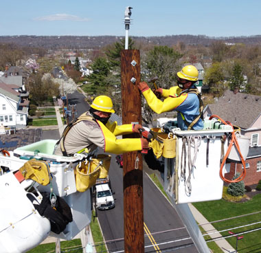 PSE&G lineworkers shown working on pole in Somerville New Jersey.