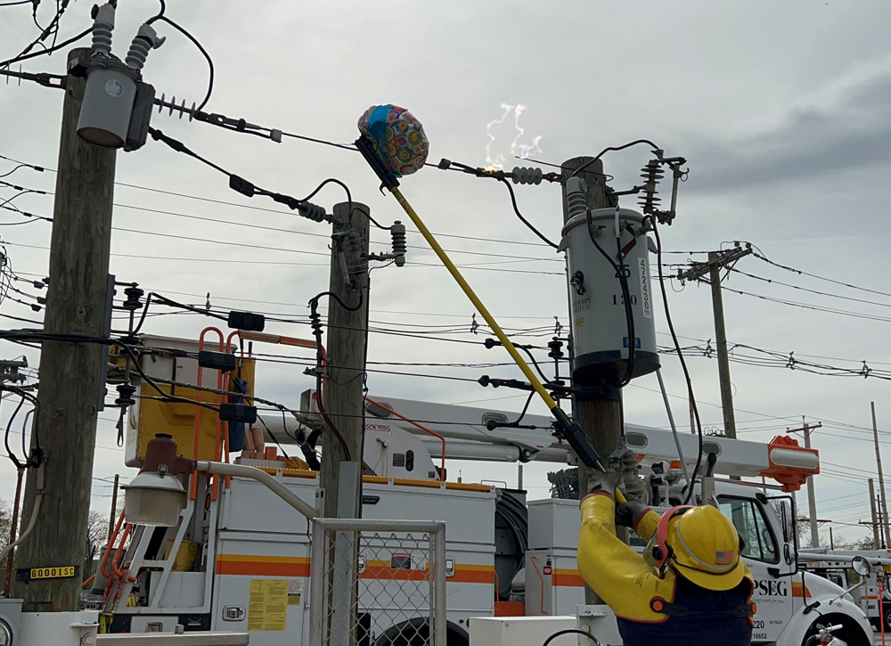 PSE&G lineworker demonstrating what happens when a mylar balloon comes in contact with an electrified power line.