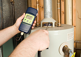 Close up of a man testing a home heating appliance