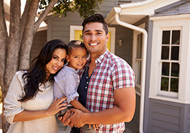 Smiling family holding a young boy