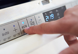 Hands adjusting a programmable thermostat