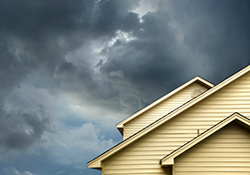 Stormy skies behind house roof