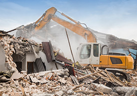 Heavy equipment demolishing a structure