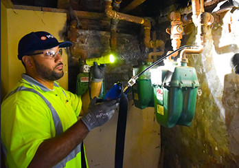 a PSE&G technician working on gas lines in a basement