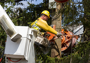 Man in a bucket truck, making repairs to a power wire