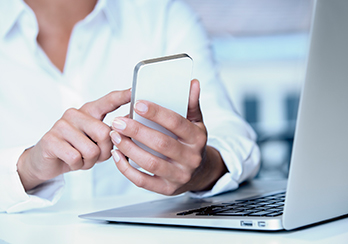 Hands holding and using a mobile phone