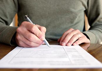 Closeup of a hand writing on paper