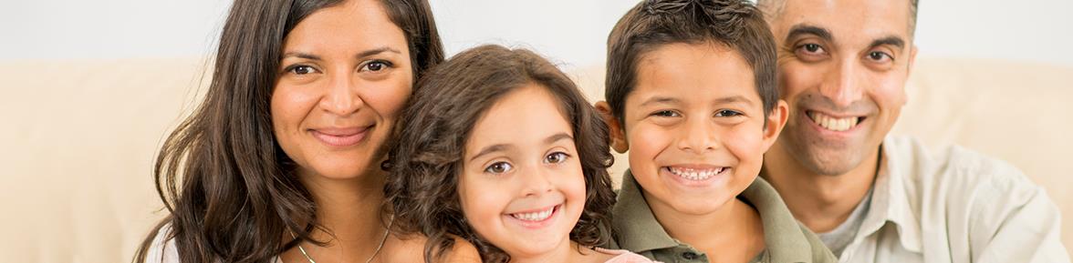Two adults and two children smiling at the camera
