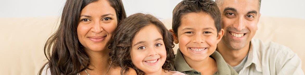 Two adults and two children smiling at the camera