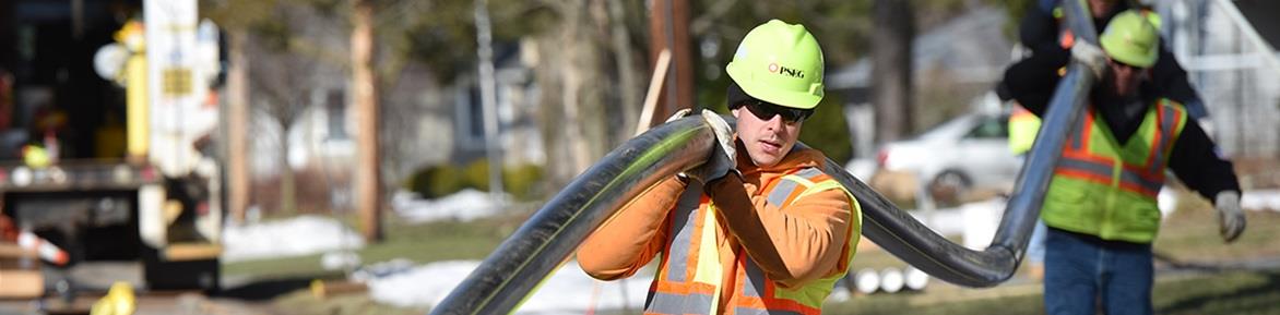 PSE&G workers carrying a gas pipe