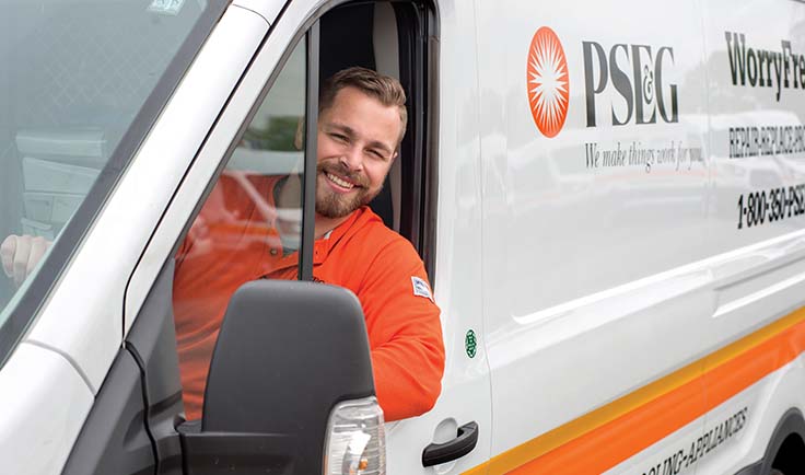  PSE&G technician leaning out of a truck window and smiling