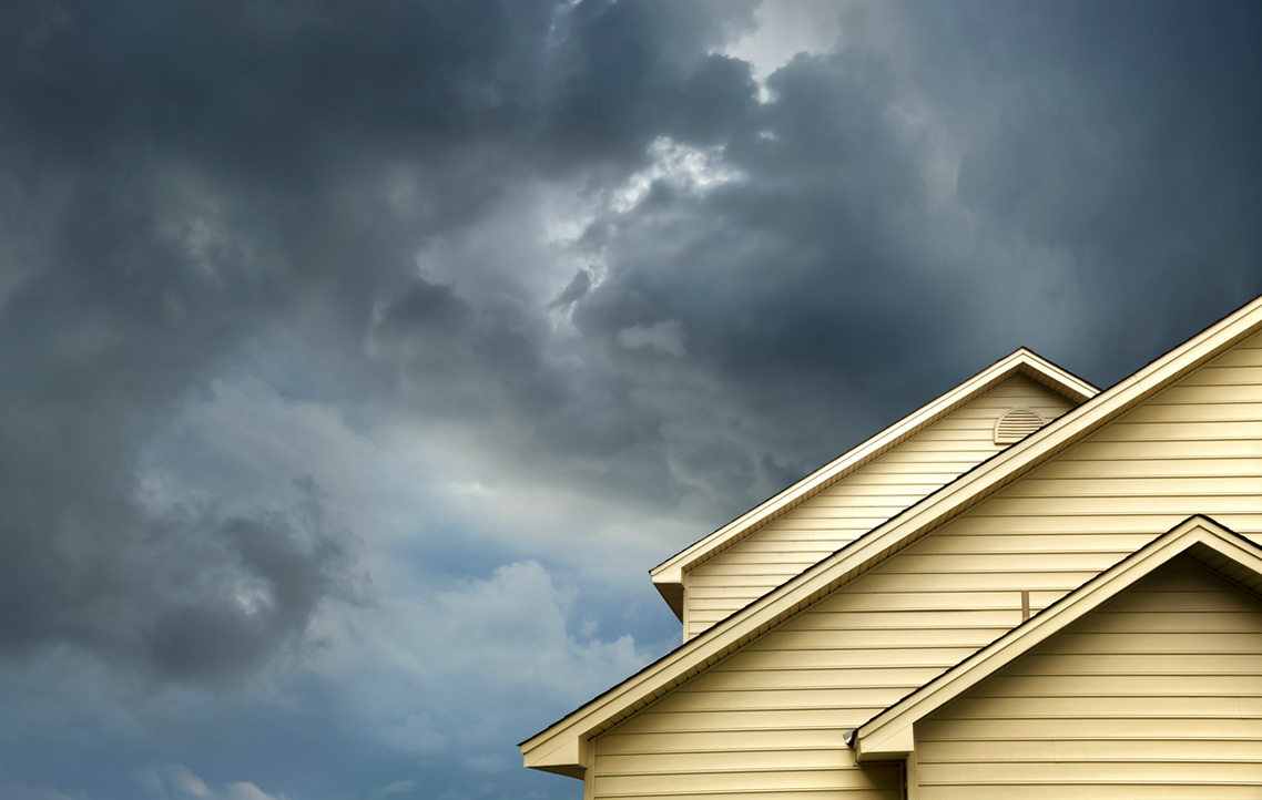 A house rooftop and a stormy sky