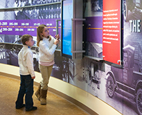 Students looking at posters/info boards in an exhibit