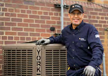 A PSE&G technician standing next to a York HVAC unit