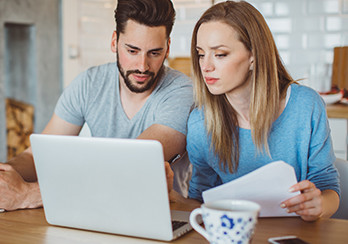 Couple looking at a laptop computer together