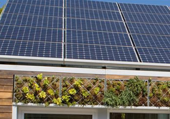 A house with solar panels on the roof is shown.