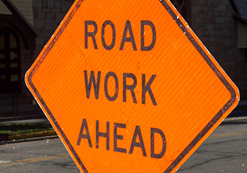 A sign that says road work ahead
