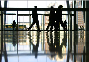 Employees walking in a building corridor is shown.