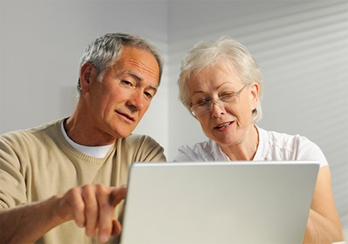 Older couple looking at a laptop computer screen