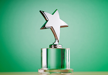 A green trophy with a gold star on top