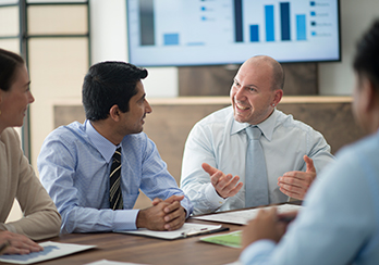 Two executives having a discussion at a conference table