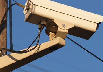 Security camera attached to a PSE&G utility pole is shown.