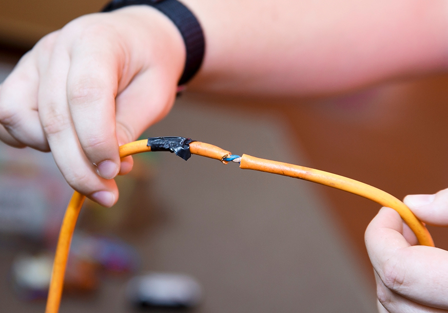  Hands holding a damaged wire