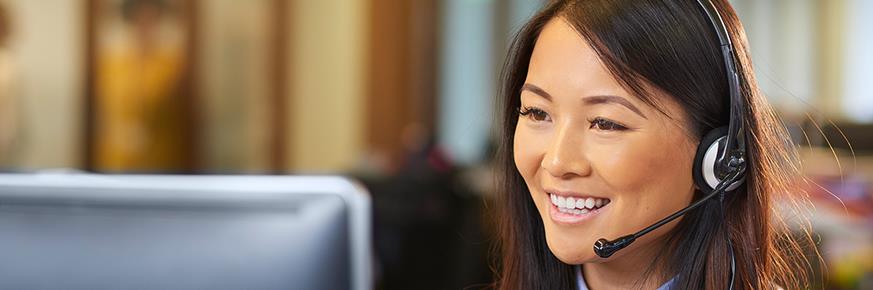 A customer service representative wearing a phone headset