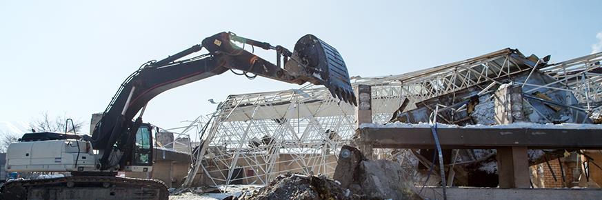 Large construction machine scooping debris