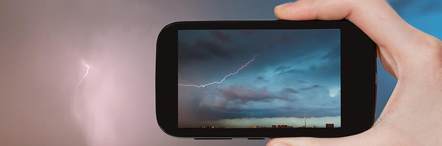 Woman looking at a smartphone in a dark room