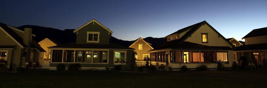 Houses with lights on at dusk