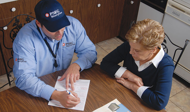PSE&G technician going over paperwork with a customer