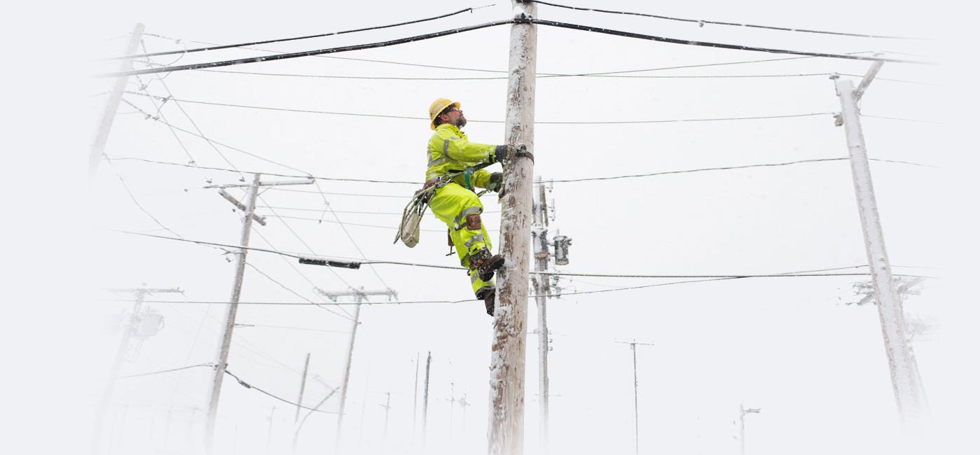 Utility line worker restoring electric service during a winter storm.